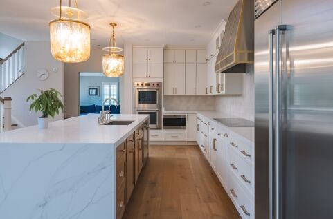 Modern kitchen remodeling project with custom cabinets and island by Build Design Center