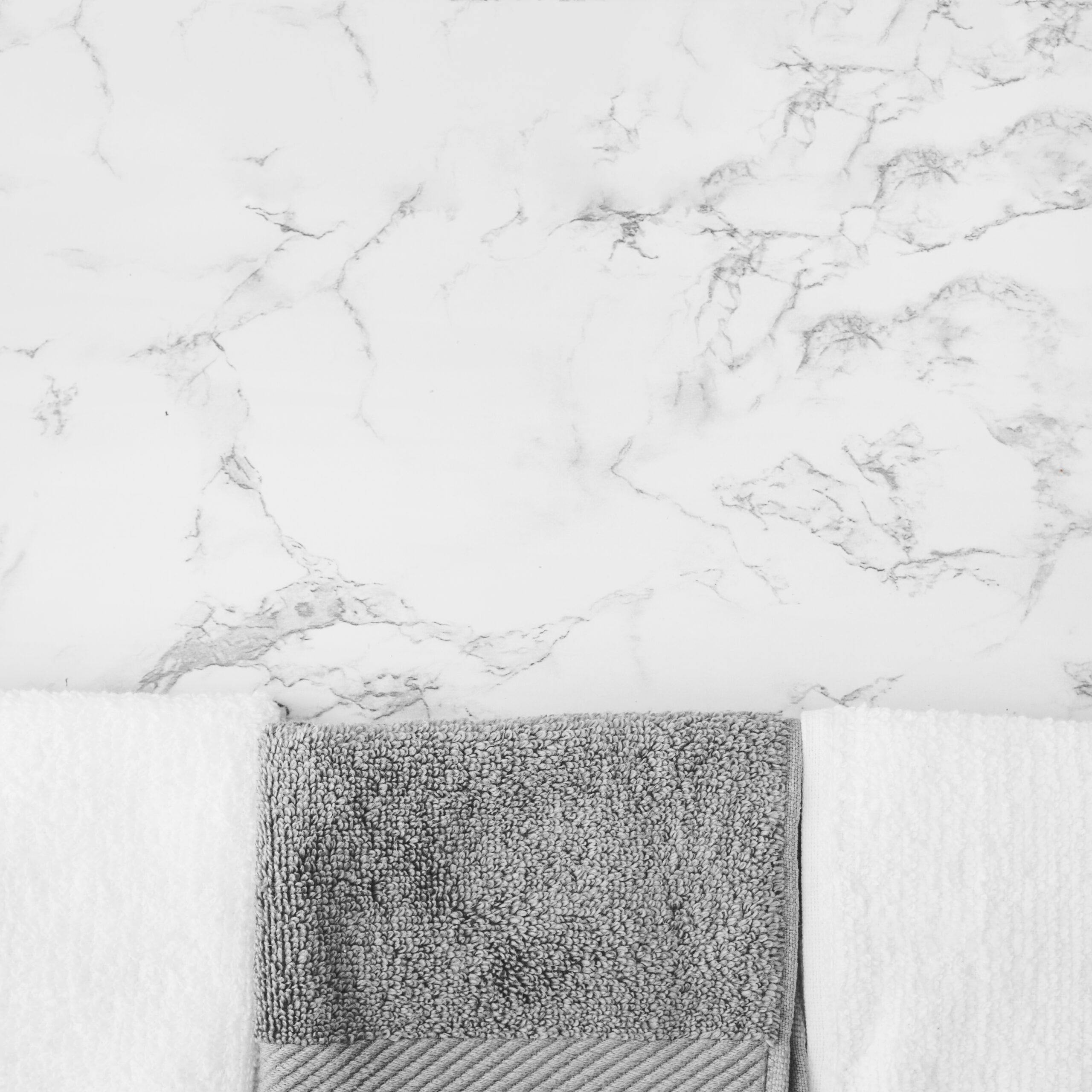 black white towels marble backdrop scaled