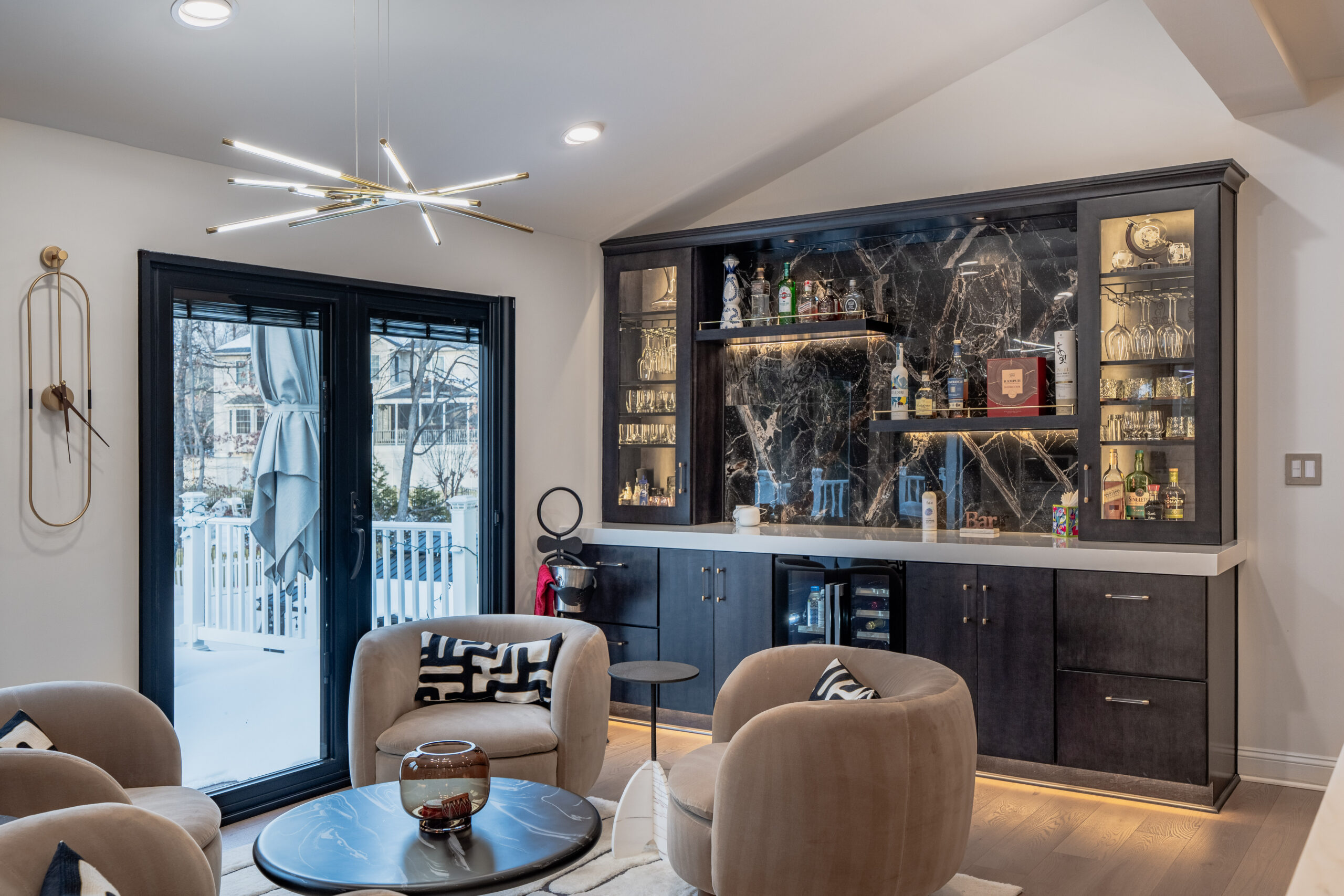 built-in home bar cabinet with glass doors, bottle display, and modern lighting