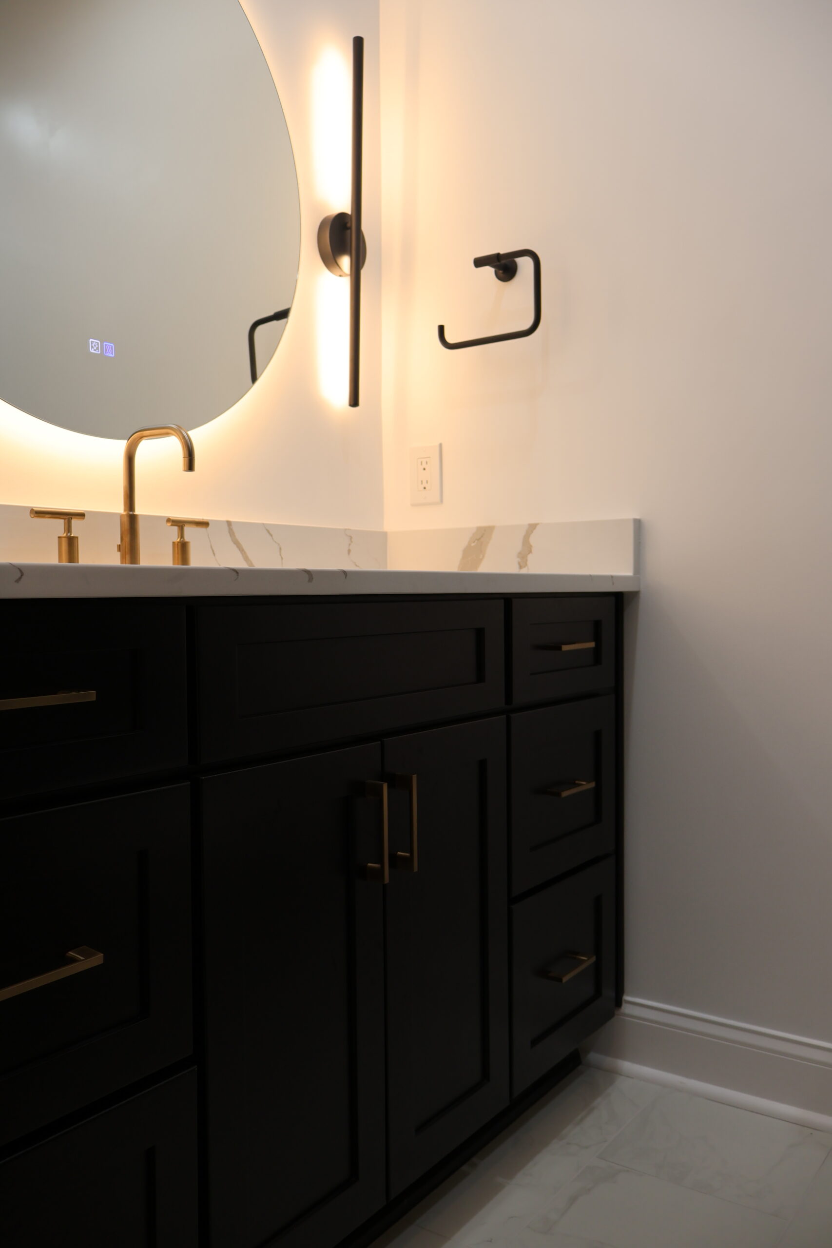 Black herringbone tile shower walls with gold plumbing fixtures for a Bathroom renovation