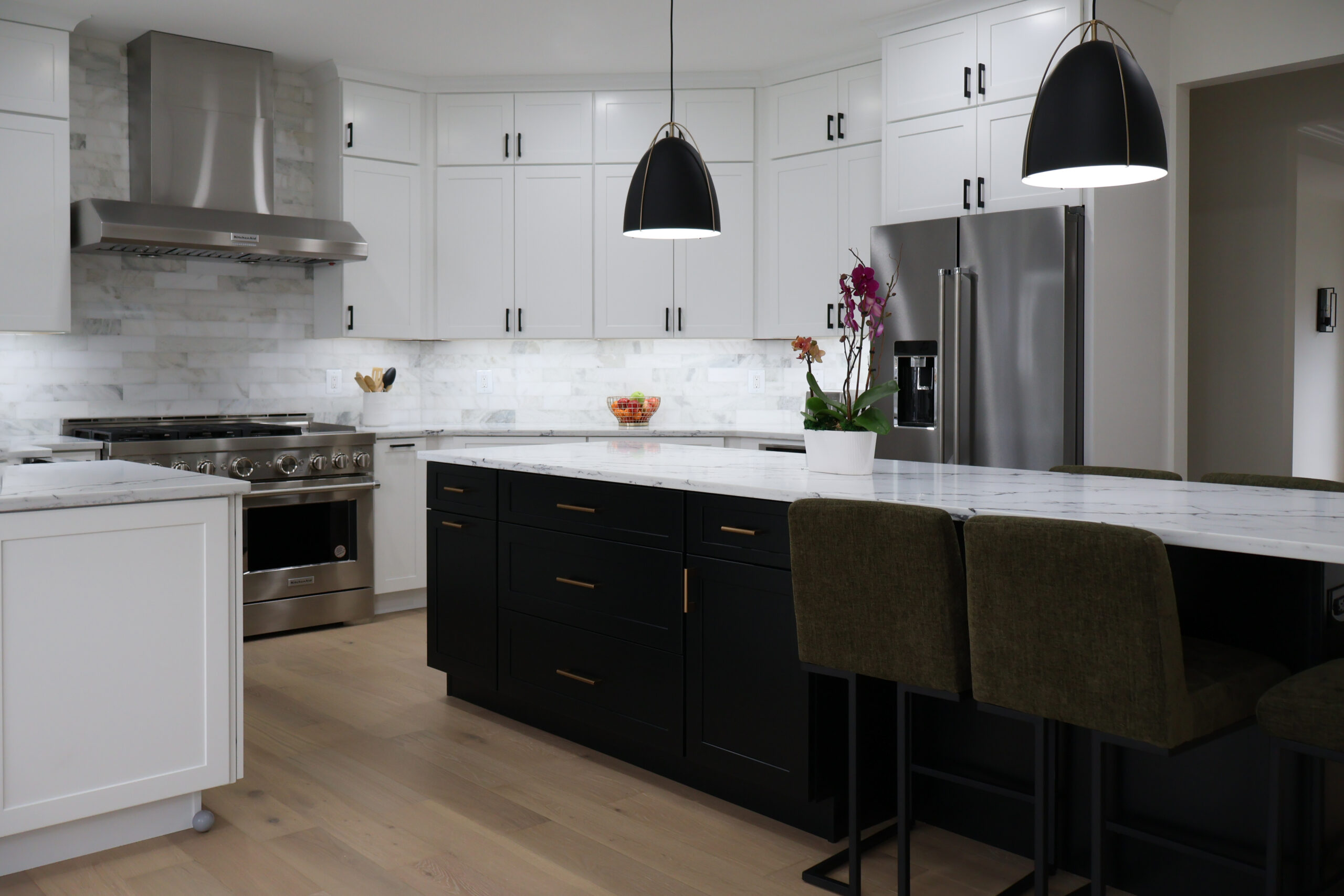 Detail of a black kitchen island with brushed gold handles for a Kitchen renovation.