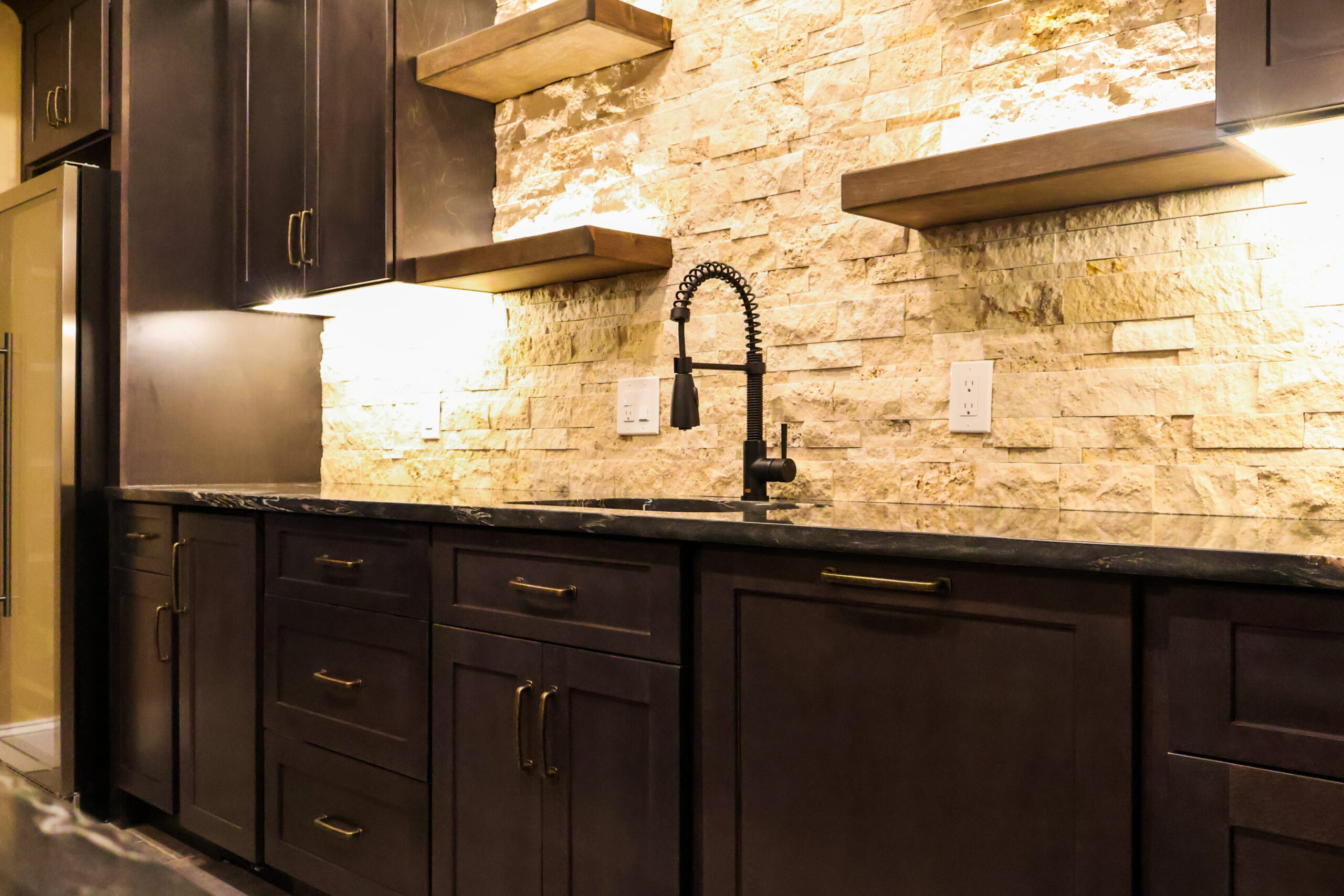 Black spring neck faucet and illuminated shelving unit