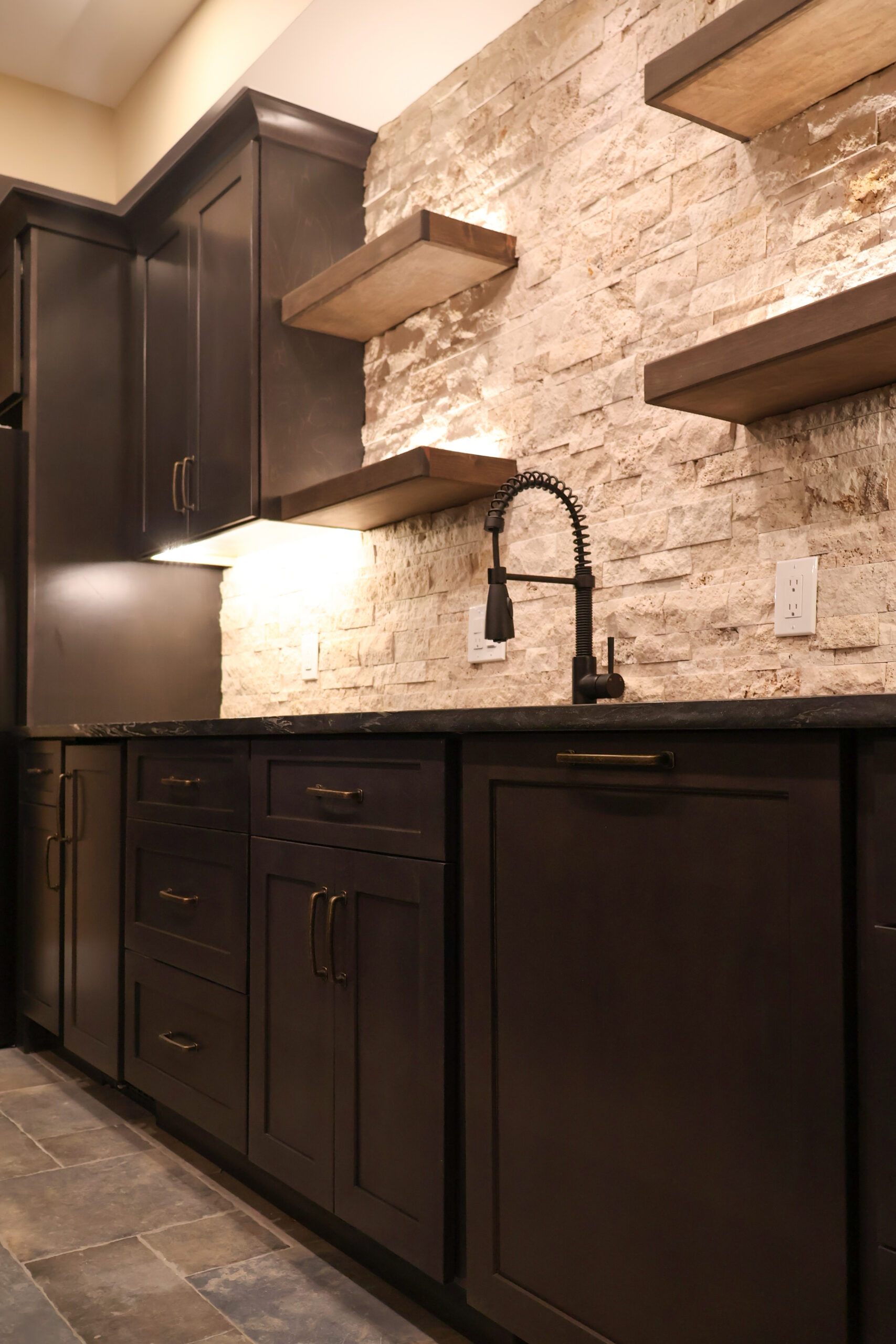 Dark kitchen cabinets and textured stone wall for a Kitchen update