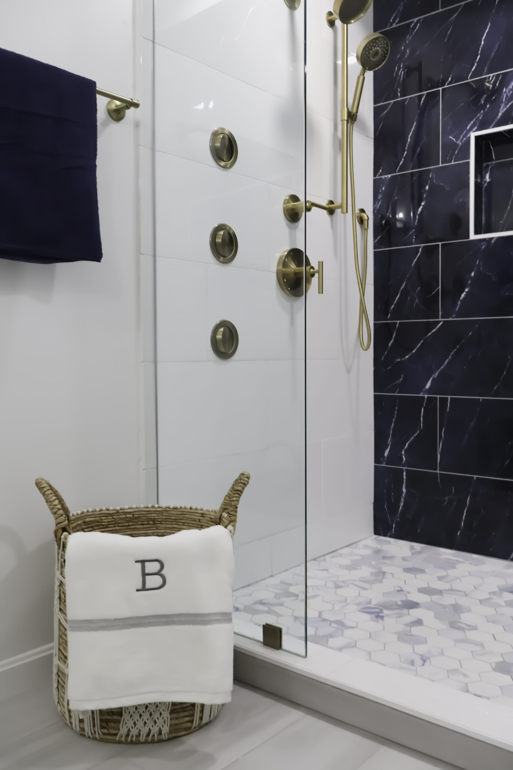 Frameless glass shower with gold body sprays for a Bathroom update