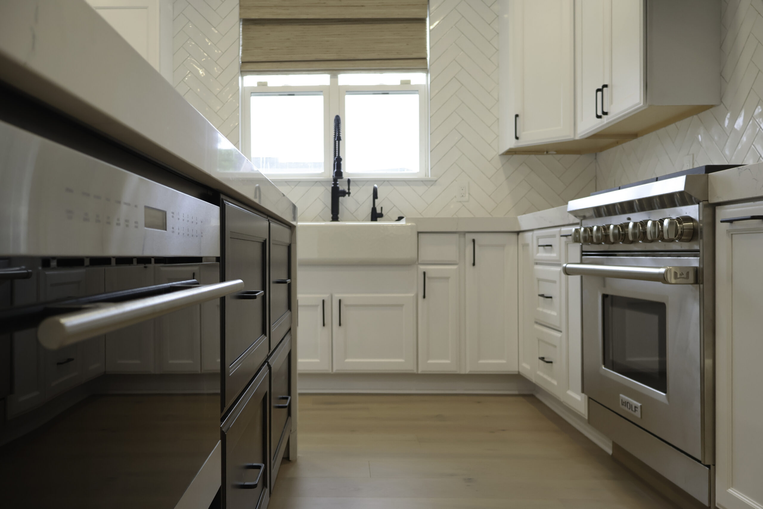 Stainless steel microwave drawer in a black kitchen island for a Kitchen update