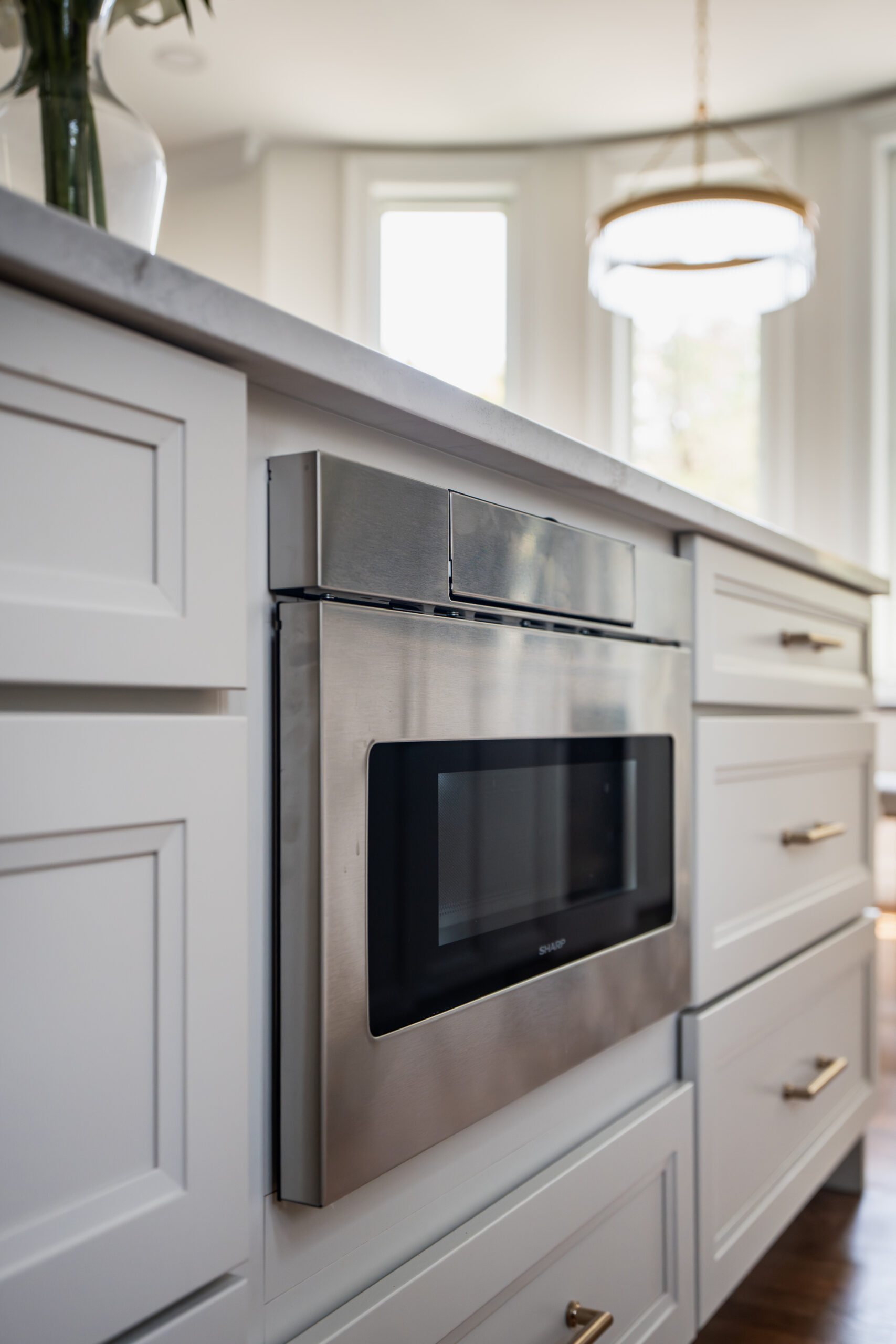 The top view of a large marble kitchen island showing a wide workspace and decorative accents.