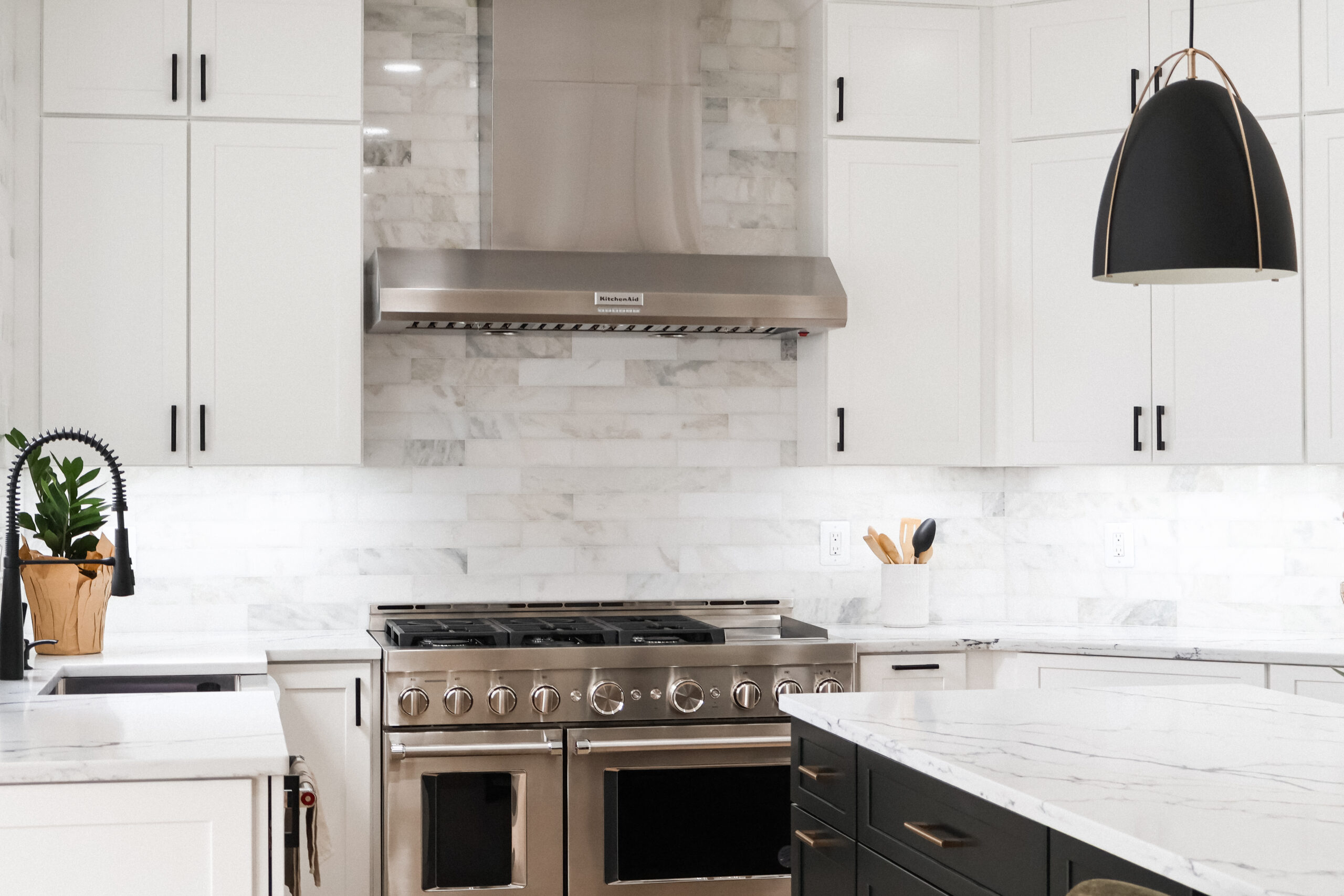 High-performance 6-burner gas range with a stainless steel wall-mounted vent hood.