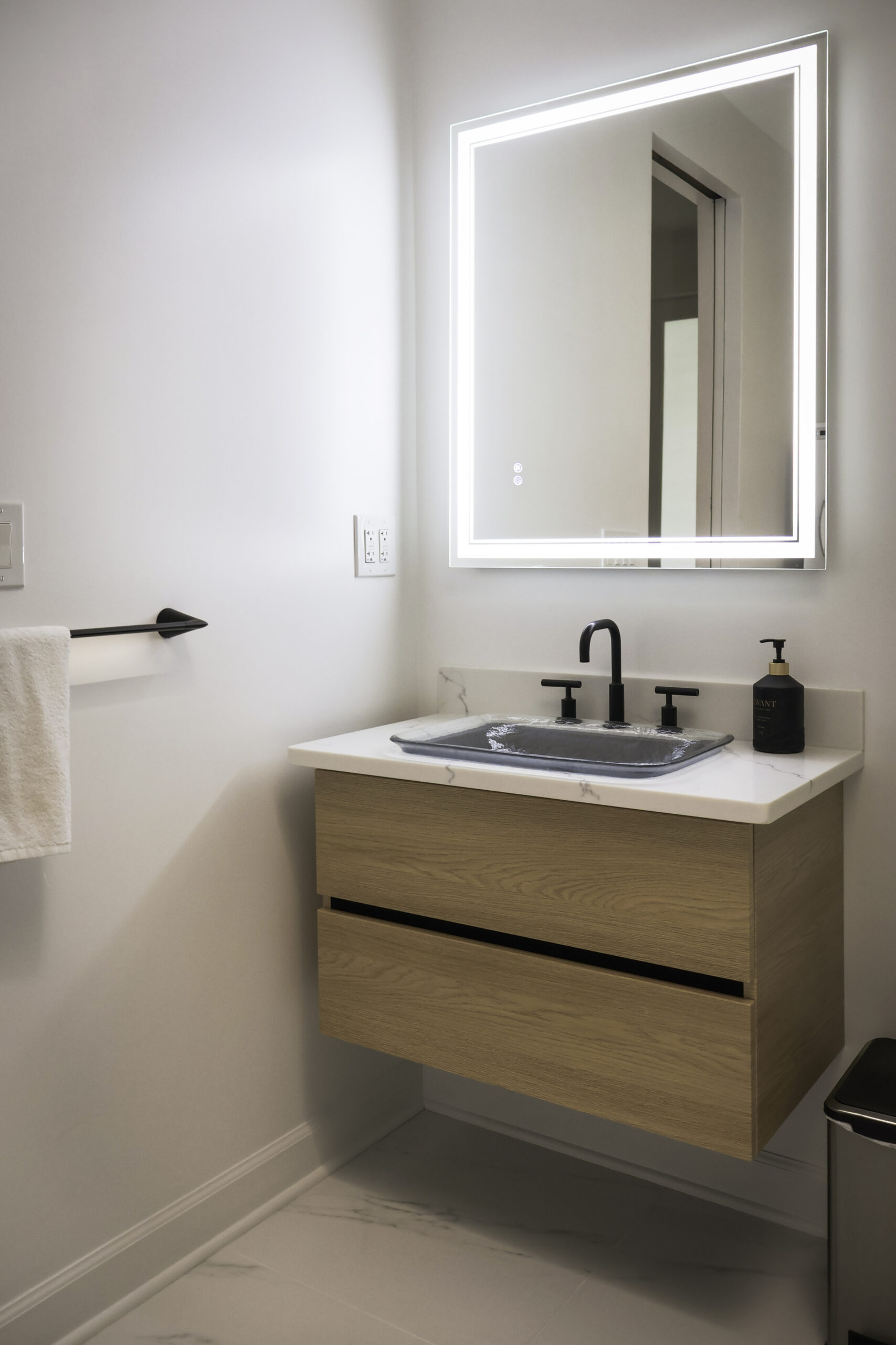 Lighted LED bathroom mirror and floating oak vanity for a Bathroom update.