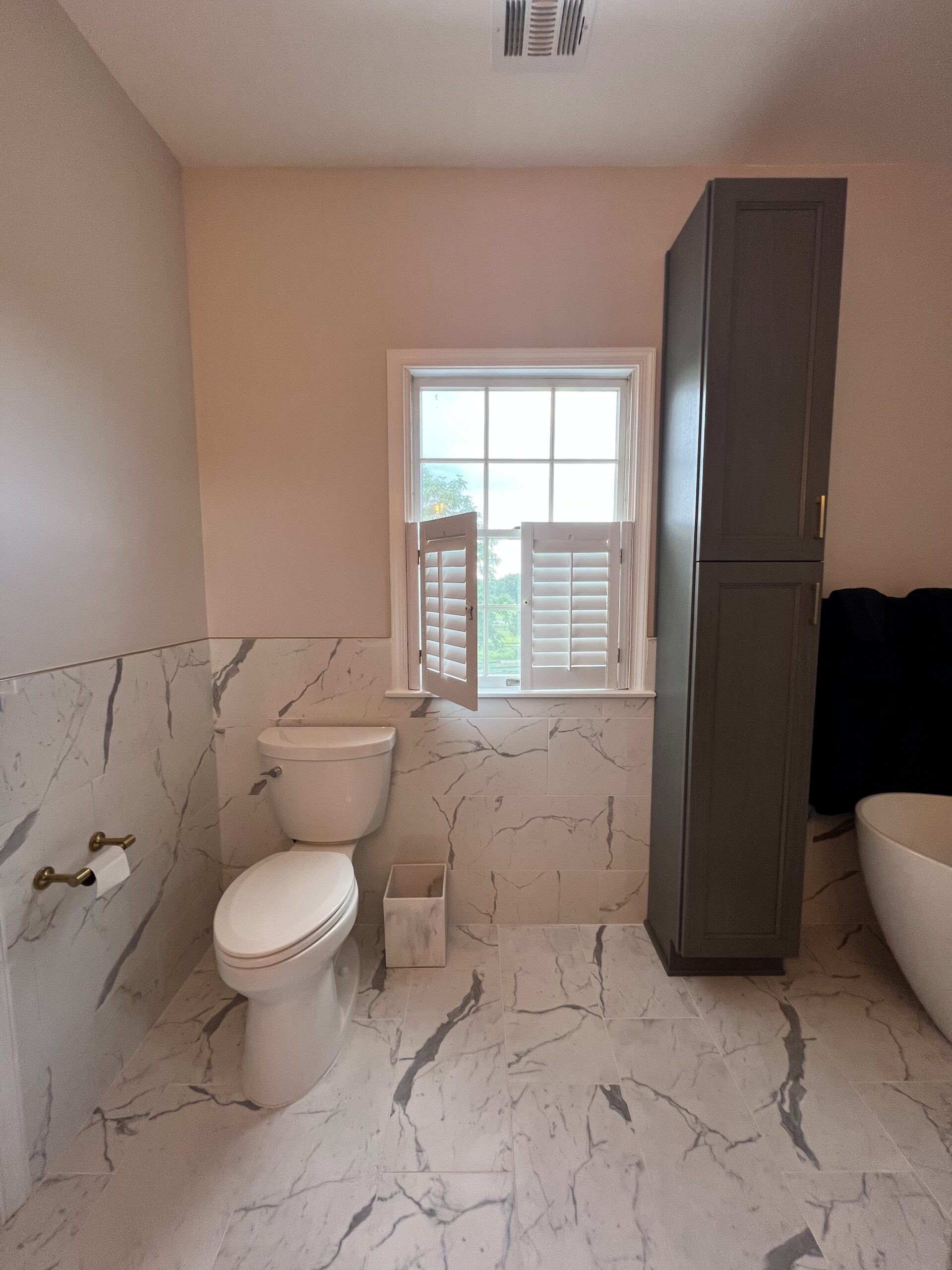 Tall linen cabinet and high-efficiency toilet for a Bathroom update.