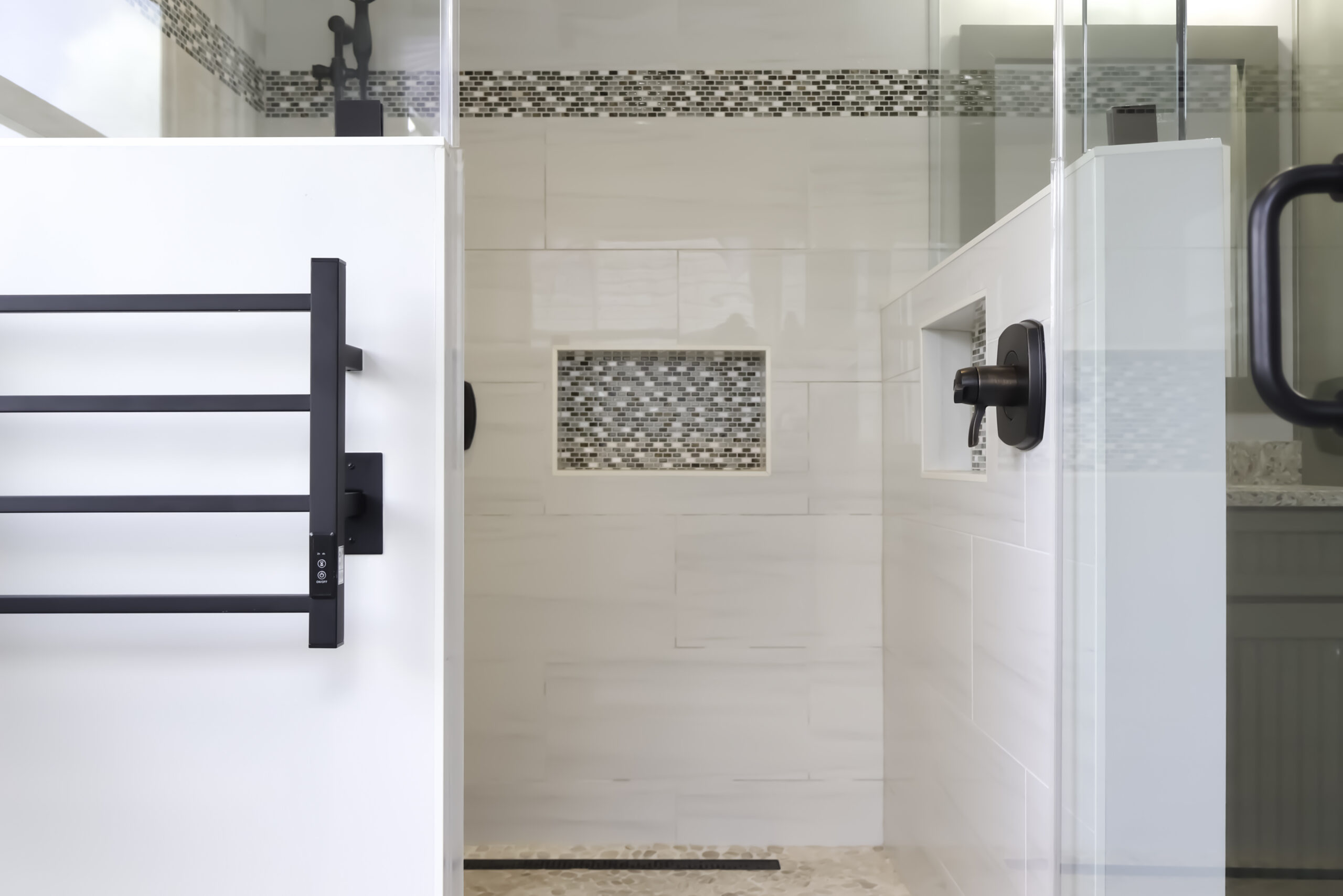 Recessed shower niche with hand-laid mosaic tile for a Bathroom renovation