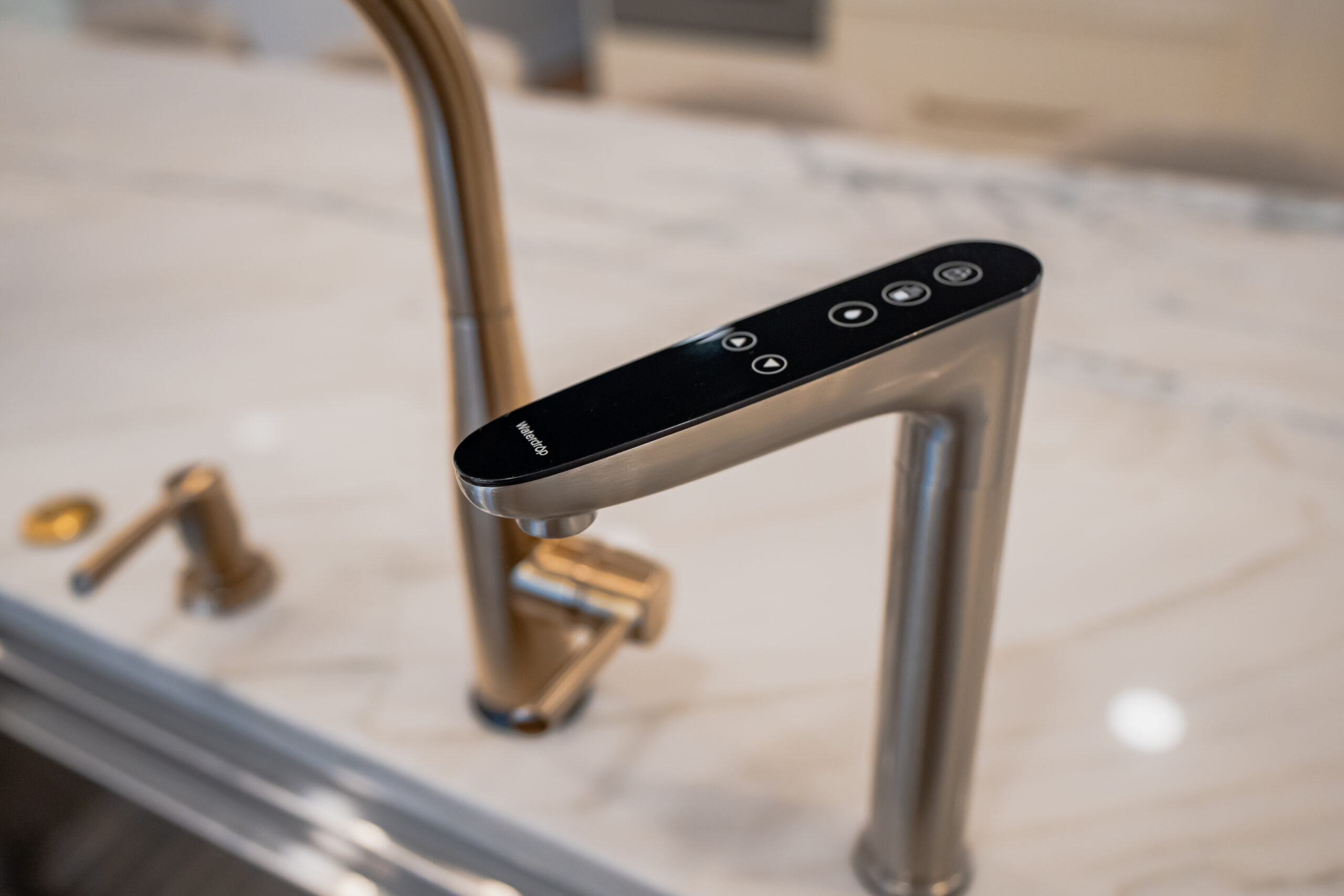 Close-up of a Waterdrop brand smart reverse osmosis water dispenser faucet with a digital interface.