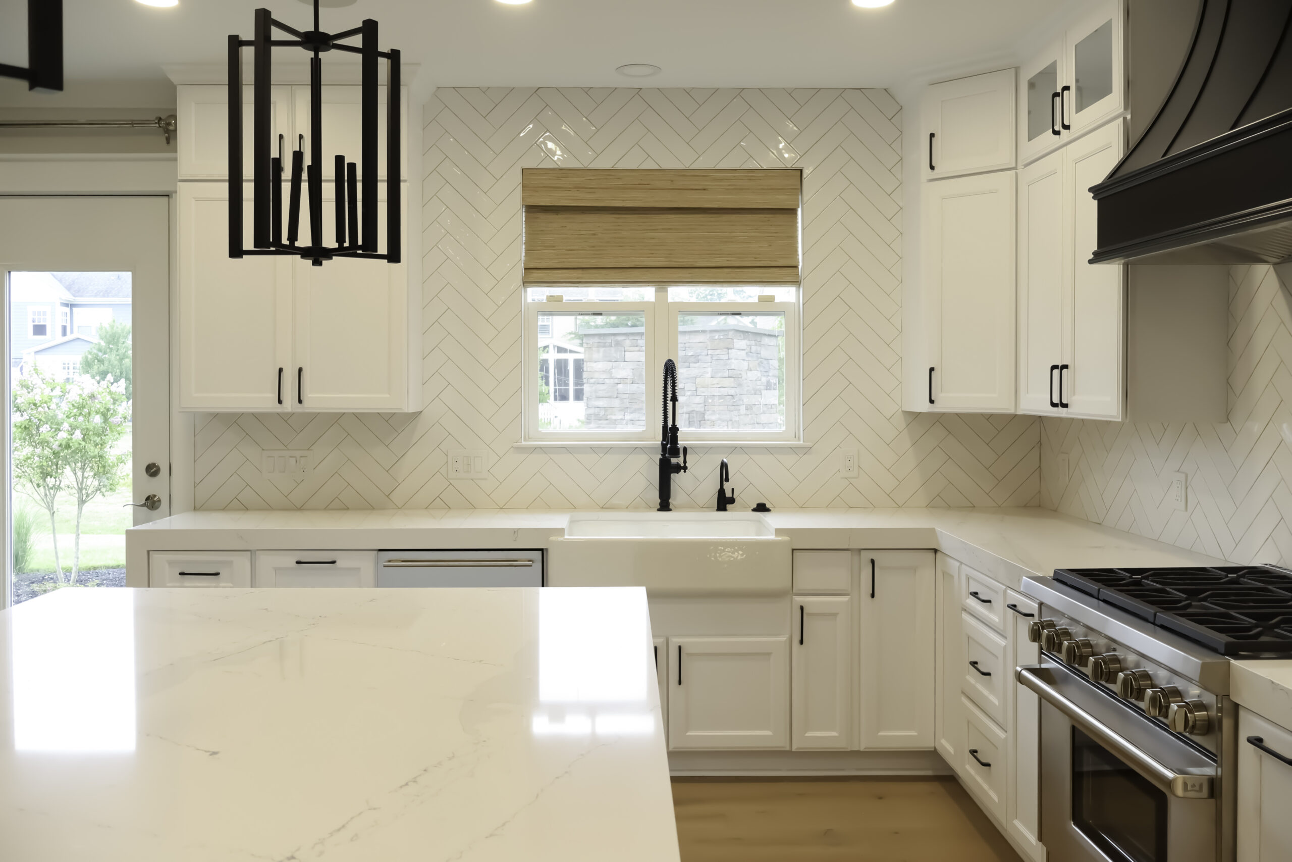 White apron front sink and herringbone tile for a Kitchen renovation