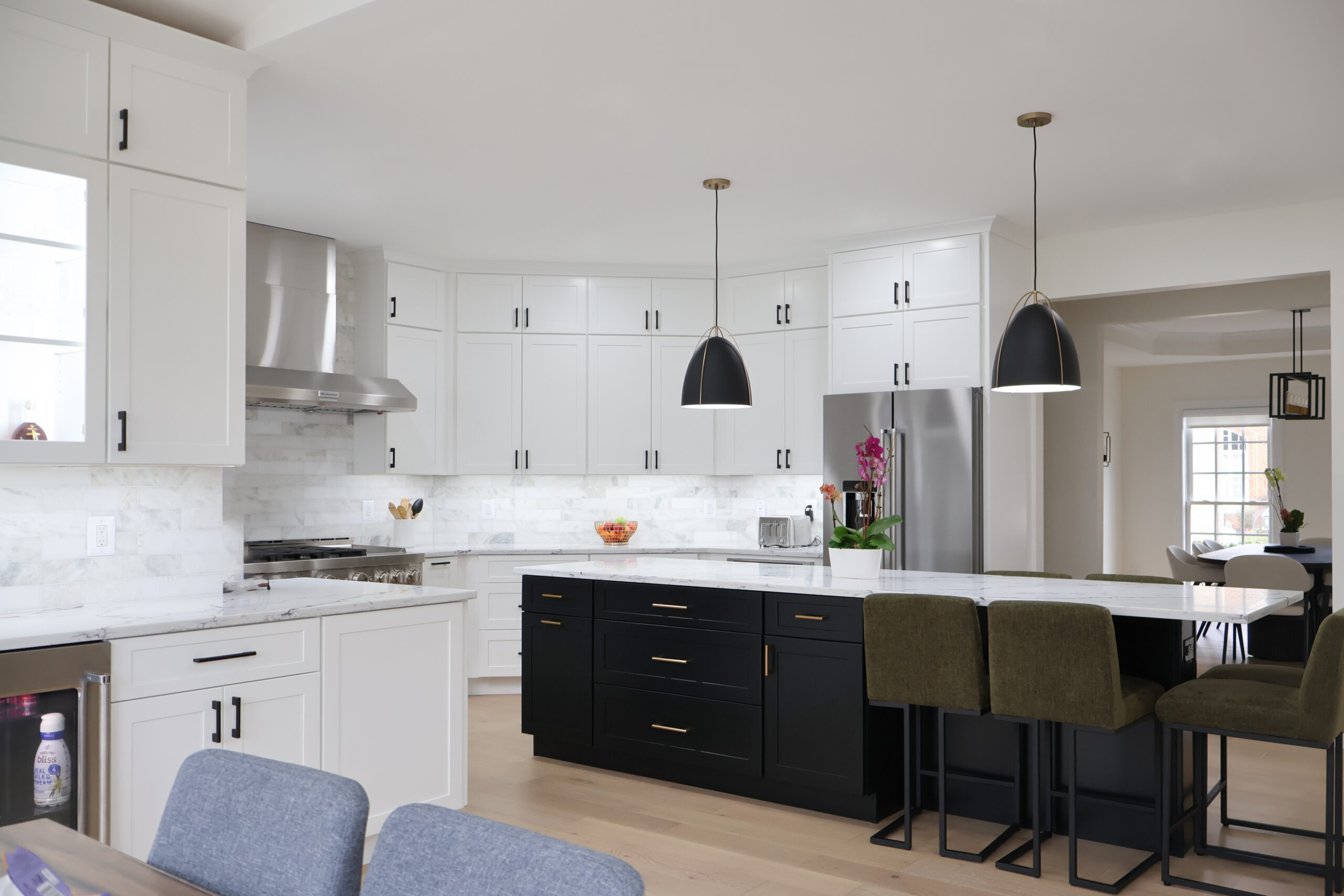 Interior view featuring floor to ceiling white cabinets and a built-in wine fridge.