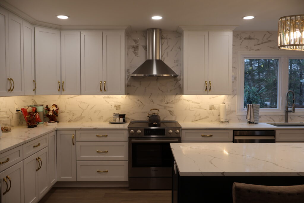 Kitchen with updated cabinetry and layered lighting over the work areas