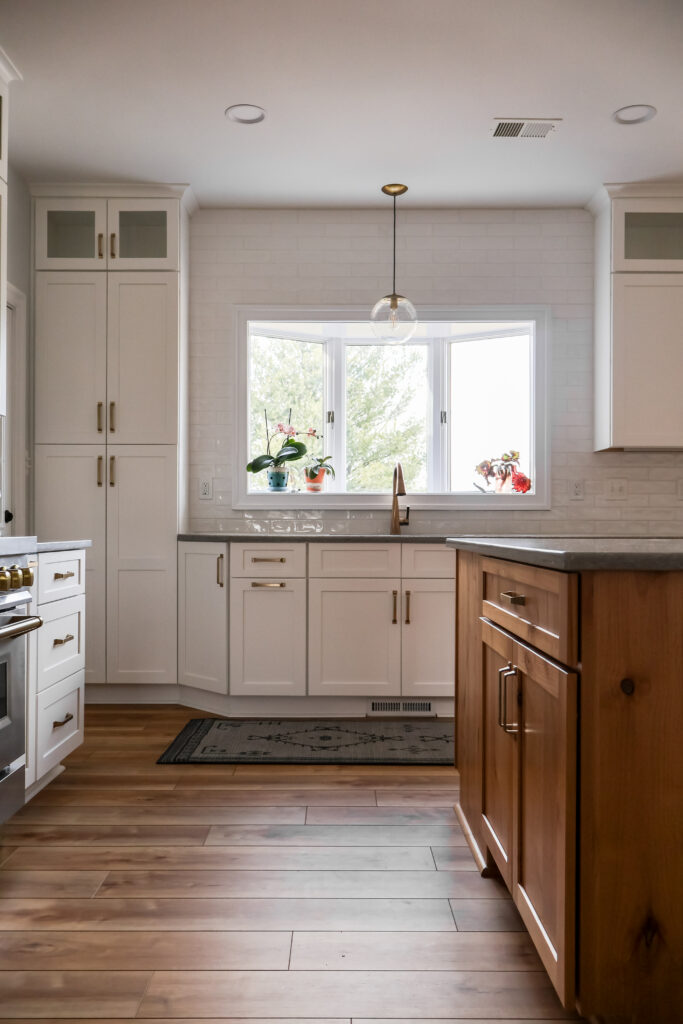 Kitchen sink positioned beneath a large window for natural light