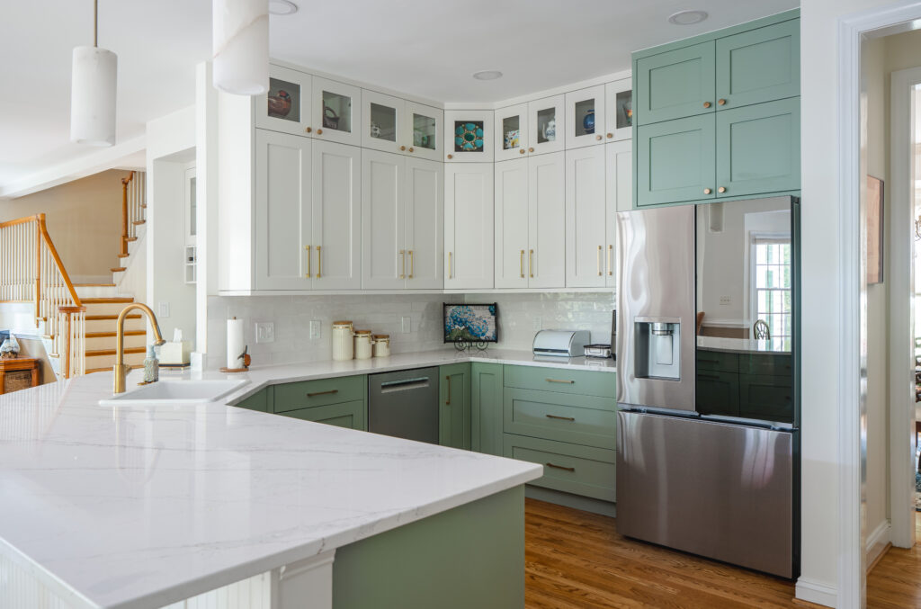 Kitchen with white and sage green cabinets and modern finishes