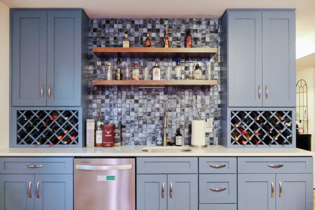 Modern basement home bar with blue cabinets and countertop